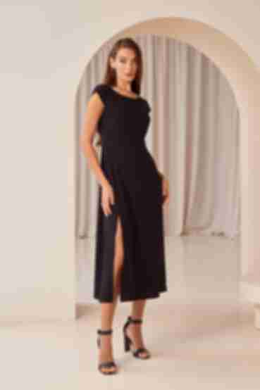 Black midaxi dress with a slit and a cutout on the back made of dense staple cotton