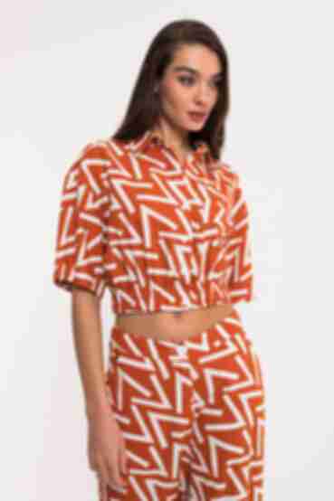 Orange cropped linen shirt with an elastic band in designer print