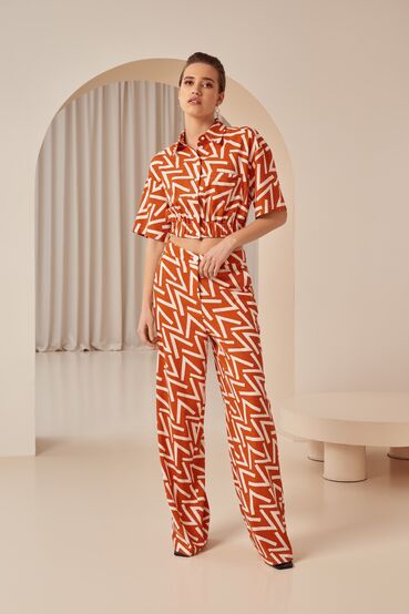 Orange straight linen trousers in designer print