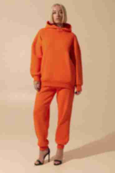 Orange suit with hooded sweatshirt and trousers made of knitted fabric with fleece