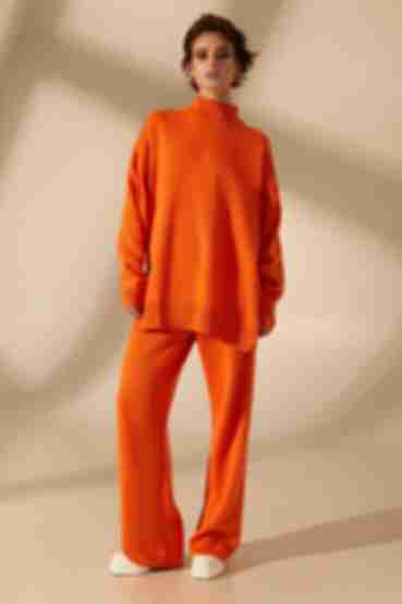 Orange knitted suit with sweater and trousers