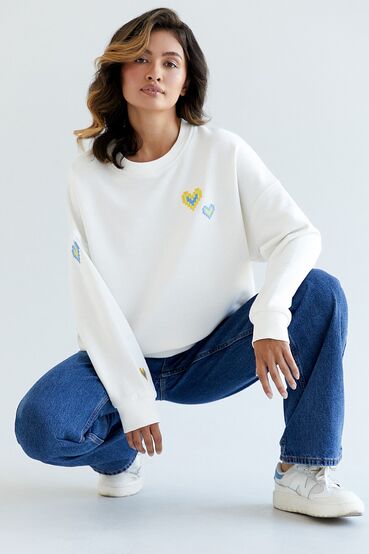 White knitted sweatshirt with "Ukrainian hearts" ornament