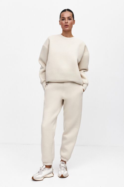 Beige sweatshirt and trousers with a pile of knitwear