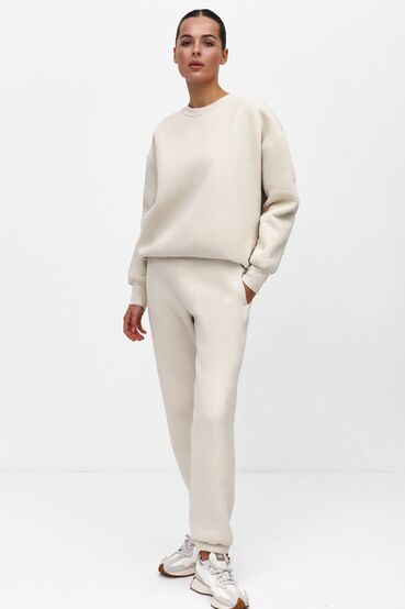 Beige sweatshirt and trousers with a pile of knitwear #2